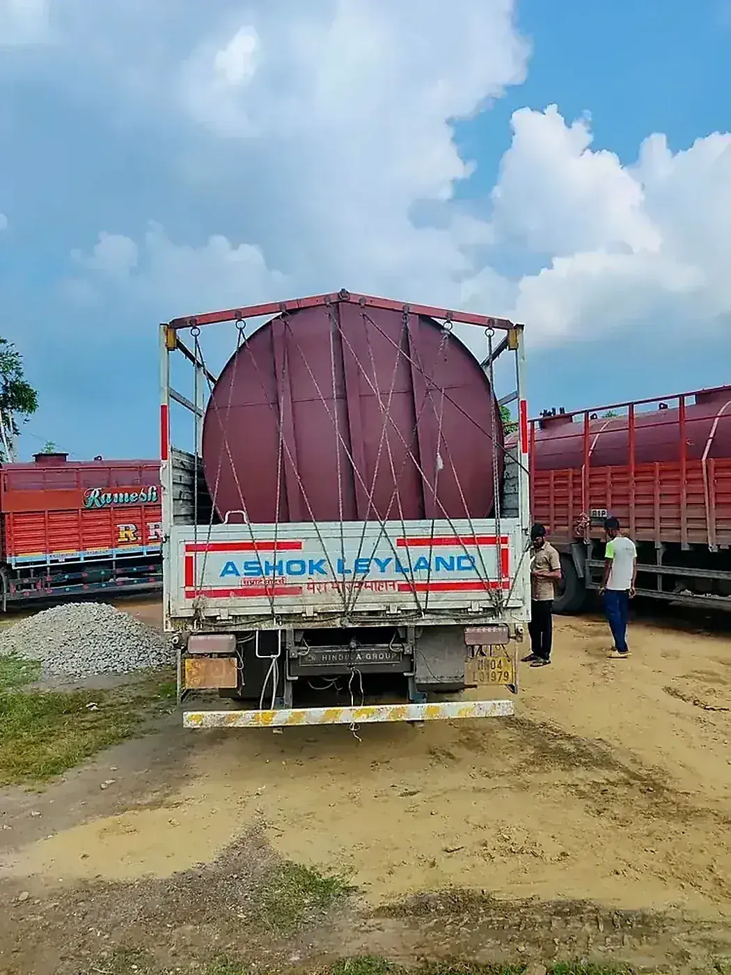 Tank loaded on Ashok Leyland truck with full rope netting — Hinduja Group fleet